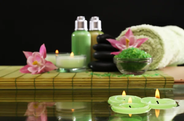 Spa still life with flowers and candlelight on black background — Stock Photo, Image