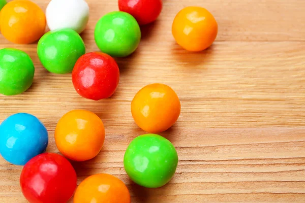 Colorful candies on wooden table, closeup — Stock Photo, Image