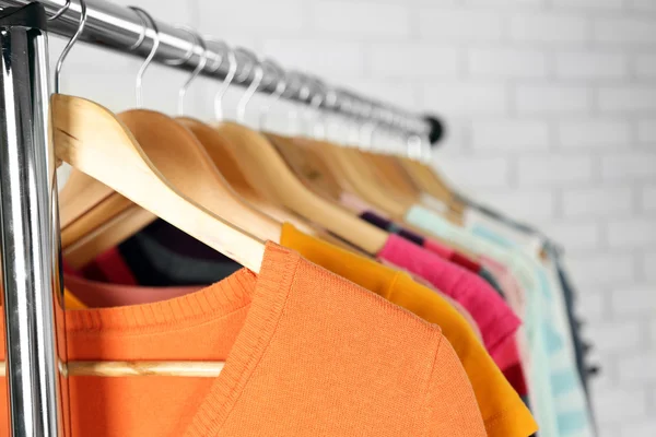 Different clothes on hangers close up — Stock Photo, Image