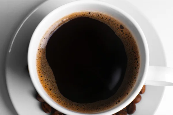 Cup of coffee with grains, top view — Stock Photo, Image