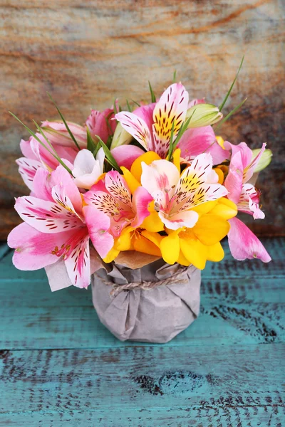 Beautiful flowers in vase on wooden background — Stock Photo, Image