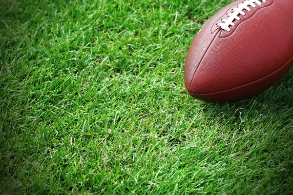 Rugby ball on green field — Stock Photo, Image