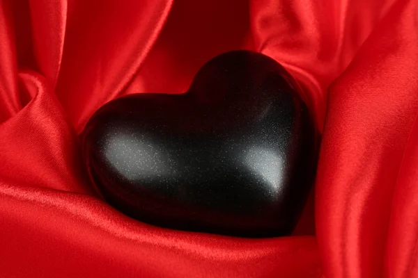 Black heart on fabric background — Stock Photo, Image