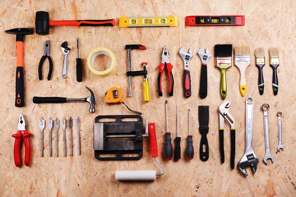 Set of tools on plywood, top view — Stock Photo, Image