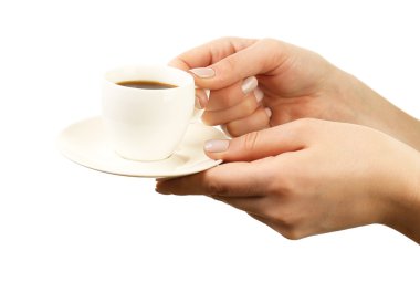 Female hands holding cup of coffee with saucer