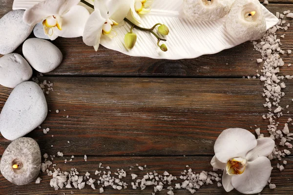 Spa stones and orchid flower on wooden background — Stock Photo, Image