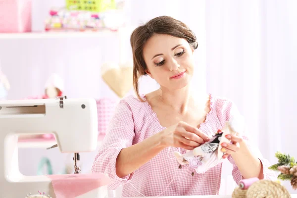 Beautiful young needlewoman in workshop — Stock Photo, Image