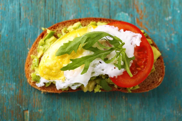 Sabroso sándwich con huevo, aguacate y verduras sobre fondo de madera —  Fotos de Stock