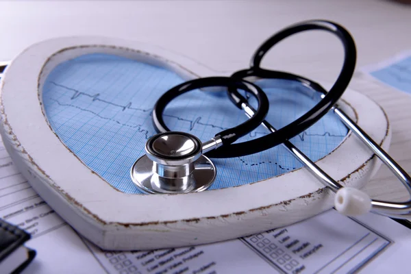 Cardiogram with stethoscope on table, closeup — Stock Photo, Image