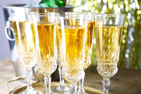 Glasses of champagne on bright background — Stock Photo, Image