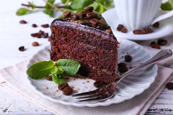 Delicioso pastel de chocolate con menta en el plato en la mesa de cerca — Foto de Stock