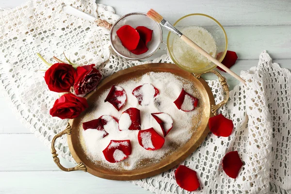 Making candied rose flower petals with egg whites and sugar, on wooden background — Stock Photo, Image