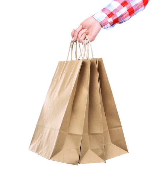 Ženská ruka drží papírové nákupní taškou izolovaných na bílém pozadí — Stock fotografie