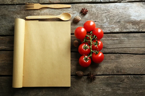 Ανοίξτε το βιβλίο συνταγών, λαχανικά και μπαχαρικά σε φόντο ξύλινη — Φωτογραφία Αρχείου