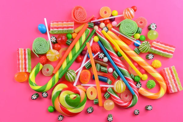 Colorful candies on pink background — Stock Photo, Image