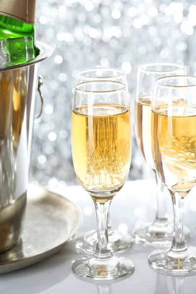 Glasses of champagne on bright background — Stock Photo, Image