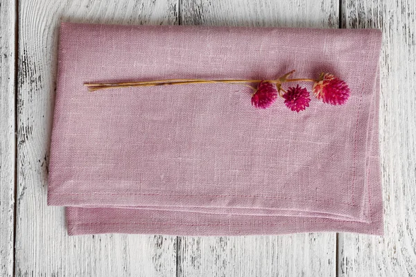 Beautiful dry flowers on napkin on wooden table close up — Stock Photo, Image