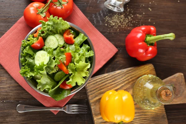 Färska grönsaker sallad i skål på bordet på nära håll — Stockfoto