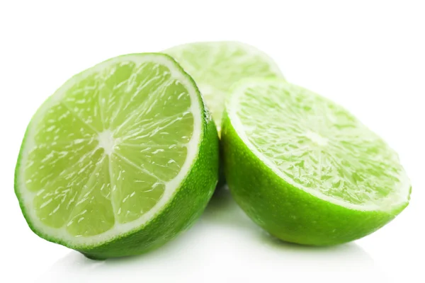 Sliced fresh limes isolated on white — Stock Photo, Image