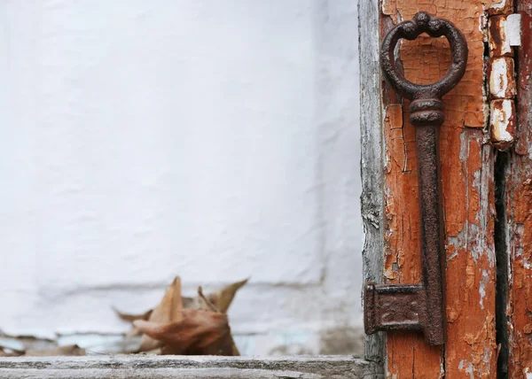 Old key on wooden antique door close-up — Stock Photo, Image