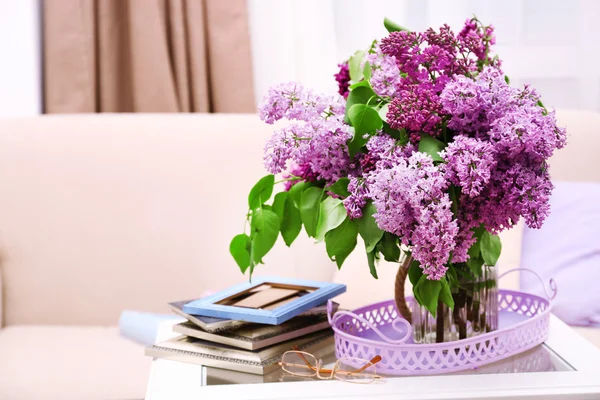 Schöne fliederfarbene Blumen in der Vase auf dem Tisch des Innenhintergrunds — Stockfoto