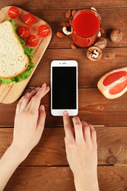 Gıda ve eller içinde hareket eden telefon
