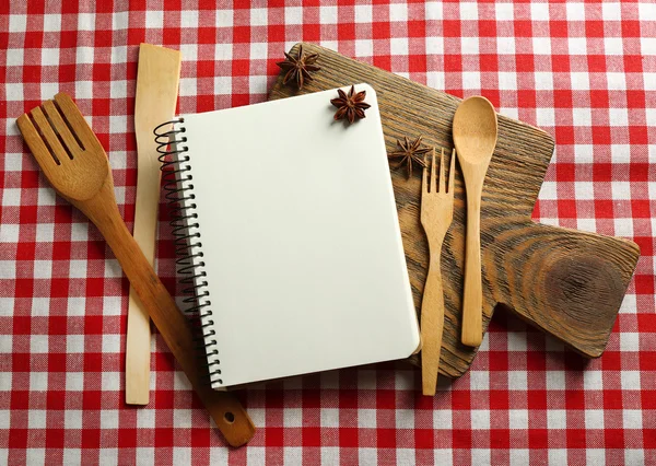 Open recipe book on tablecloth — Stock Photo, Image