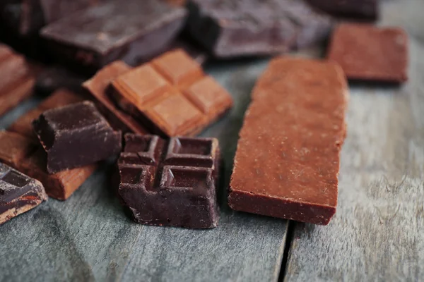 Set of chocolate on wooden table, closeup — Stock Photo, Image