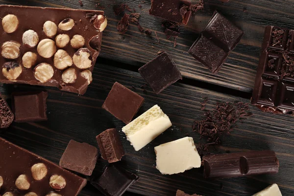 Set of chocolate with hazelnut on wooden table, top view — Stock Photo, Image