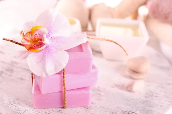 Stack of tied spa soap on wooden table, closeup — Stock Photo, Image