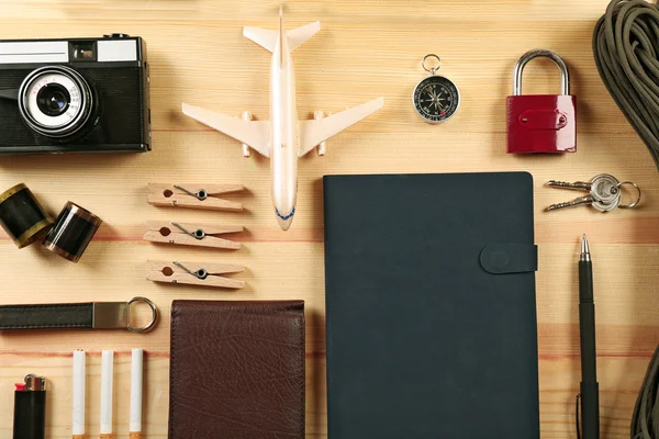 Travel gear on wooden table, top view — Stock Photo, Image