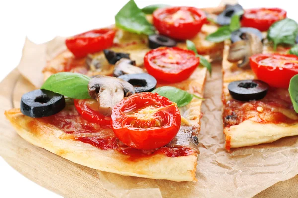 Tasty pizza with vegetables and basil on cutting board close up — Stock Photo, Image