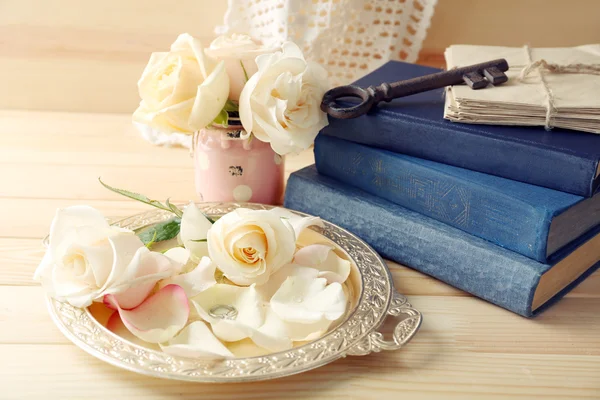 Fresh roses with old book, key and letters on wooden table background. Vintage concept — Stock Photo, Image