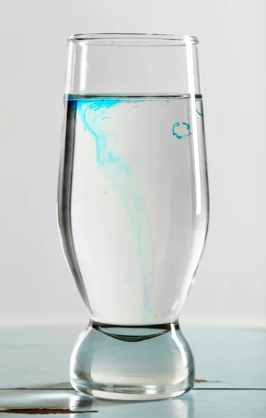 Glass of water on table on light background — Stock Photo, Image