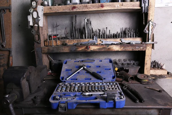 Different tools on workplace in garage — Stock Photo, Image