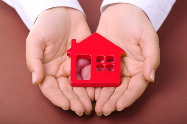 Female hands holding house — Stock Photo, Image