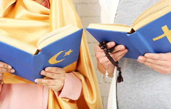 Two friends holding books with religions symbols — Stock Photo, Image