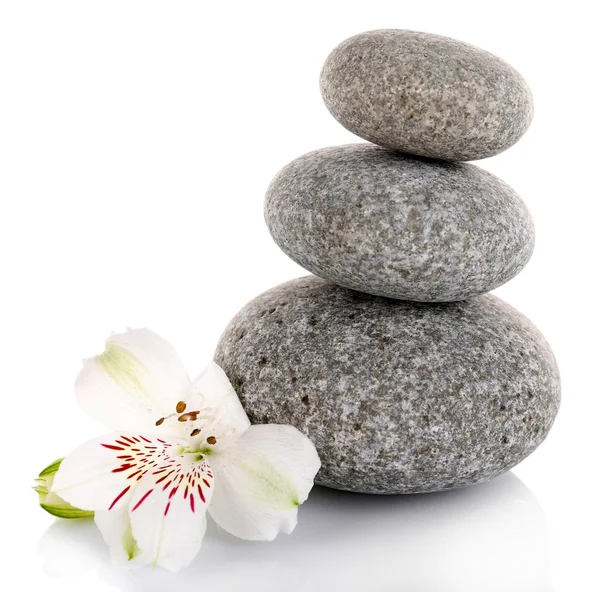 Stack of spa stones with alstroemeria isolated on white — Stock Photo, Image