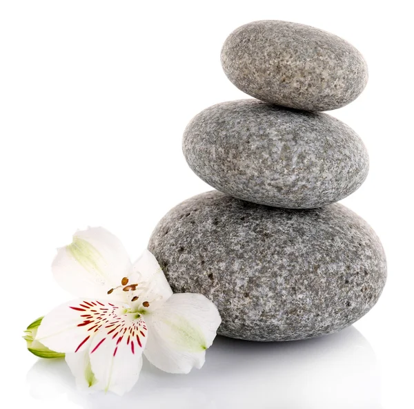 Stack of spa stones with alstroemeria isolated on white Royalty Free Stock Photos