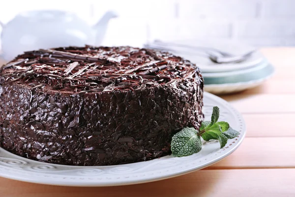 Tasty chocolate cake with mint on table — Stock Photo, Image