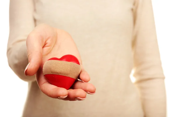 Woman holding heart with plaster — Stock Photo, Image