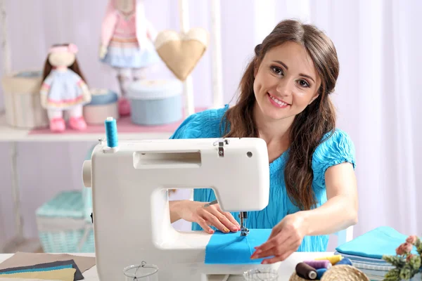 Beautiful young needlewoman in workshop — Stock Photo, Image