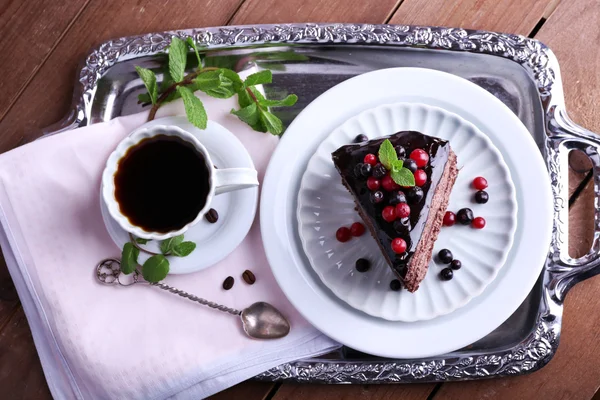 Delicioso pastel de chocolate con bayas y taza de café — Foto de Stock