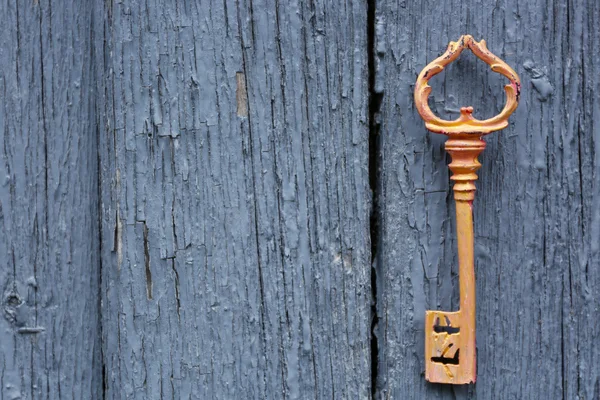 Old key on wooden antique door — Stock Photo, Image