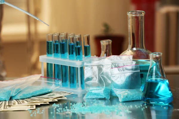 Drug laboratory: blue  methamphetamine and money — Stock Photo, Image