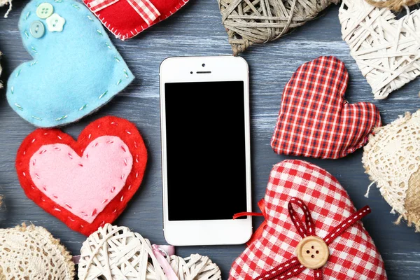 White smart phone with hearts — Stock Photo, Image