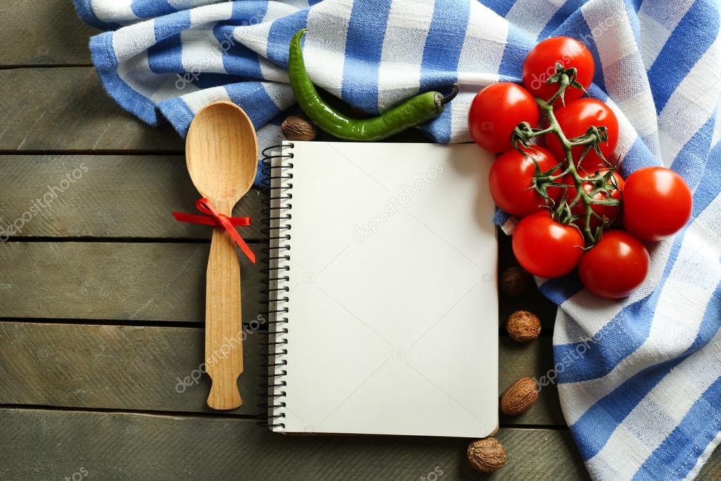 Open recipe book, vegetables and spices