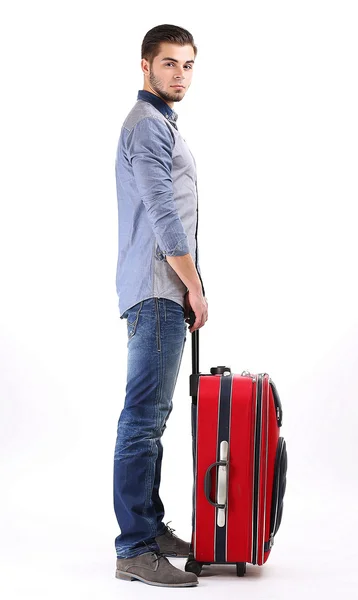 Man in het blauwe shirt en spijkerbroek met koffer geïsoleerd op wit — Stockfoto