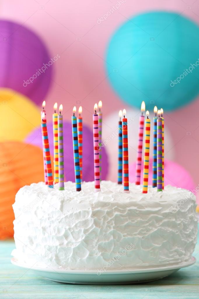 Birthday cake with candles on colorful background