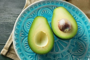 ahşap arka plan üzerinde plaka üzerinde avokado dilimlenmiş